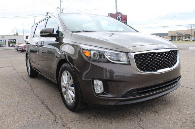 2016 Kia Sedona EX in Titanium Bronze Pearl Metallic — front three-quarter view